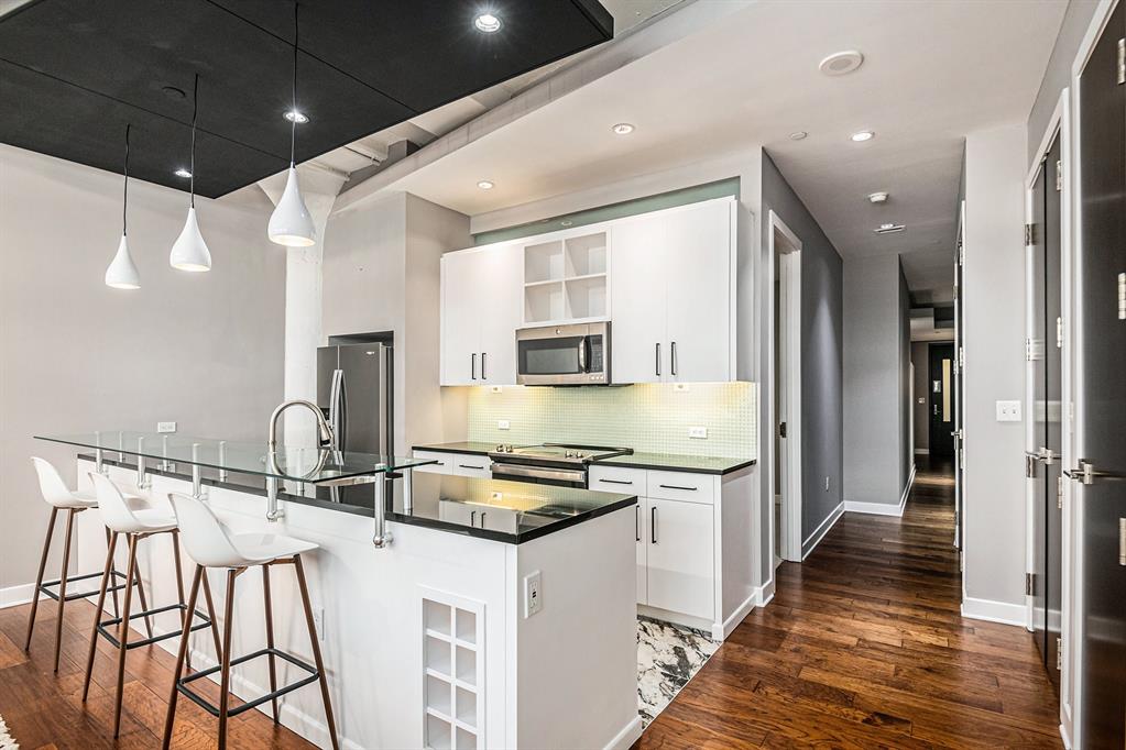 a kitchen with stainless steel appliances kitchen island granite countertop a sink and cabinets