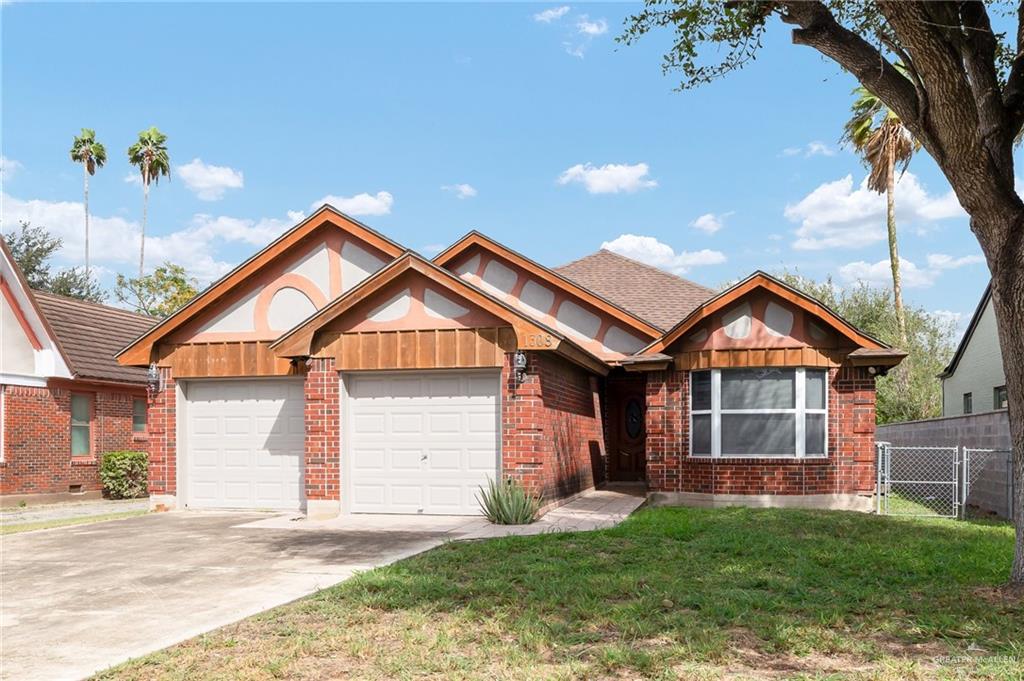 View of front facade with a front yard and a garage