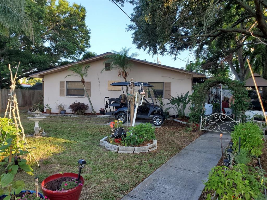 a view of a backyard with plants and a patio