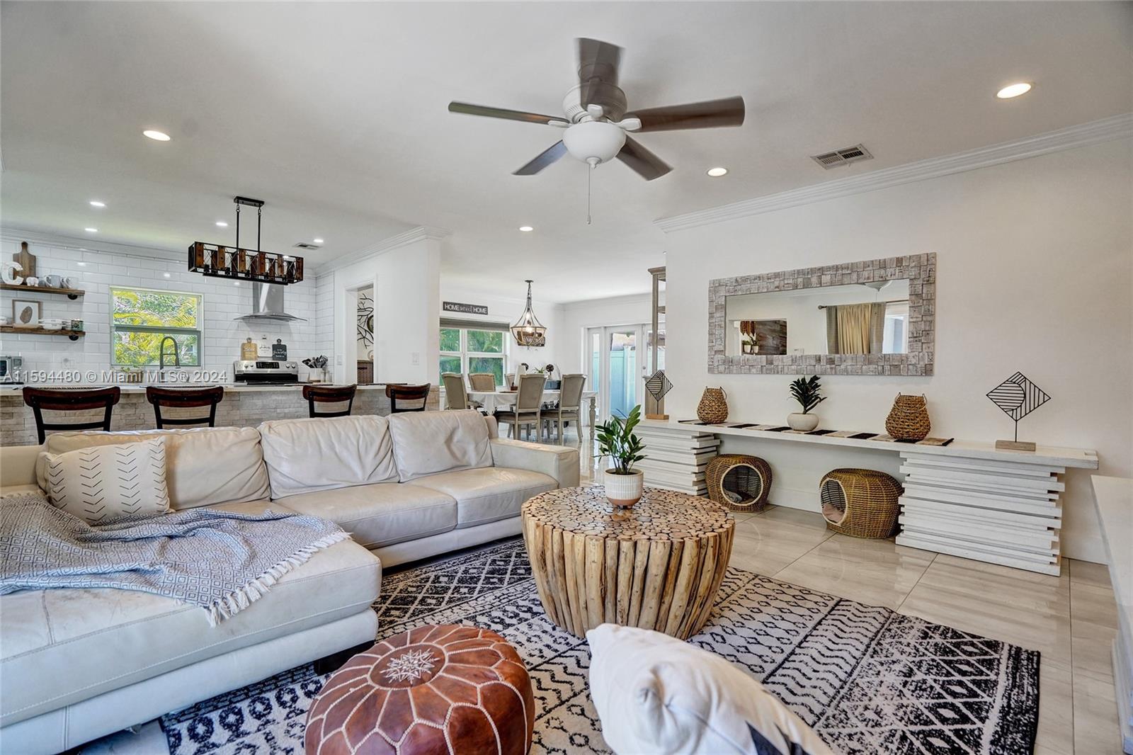 a living room with furniture a rug and white walls