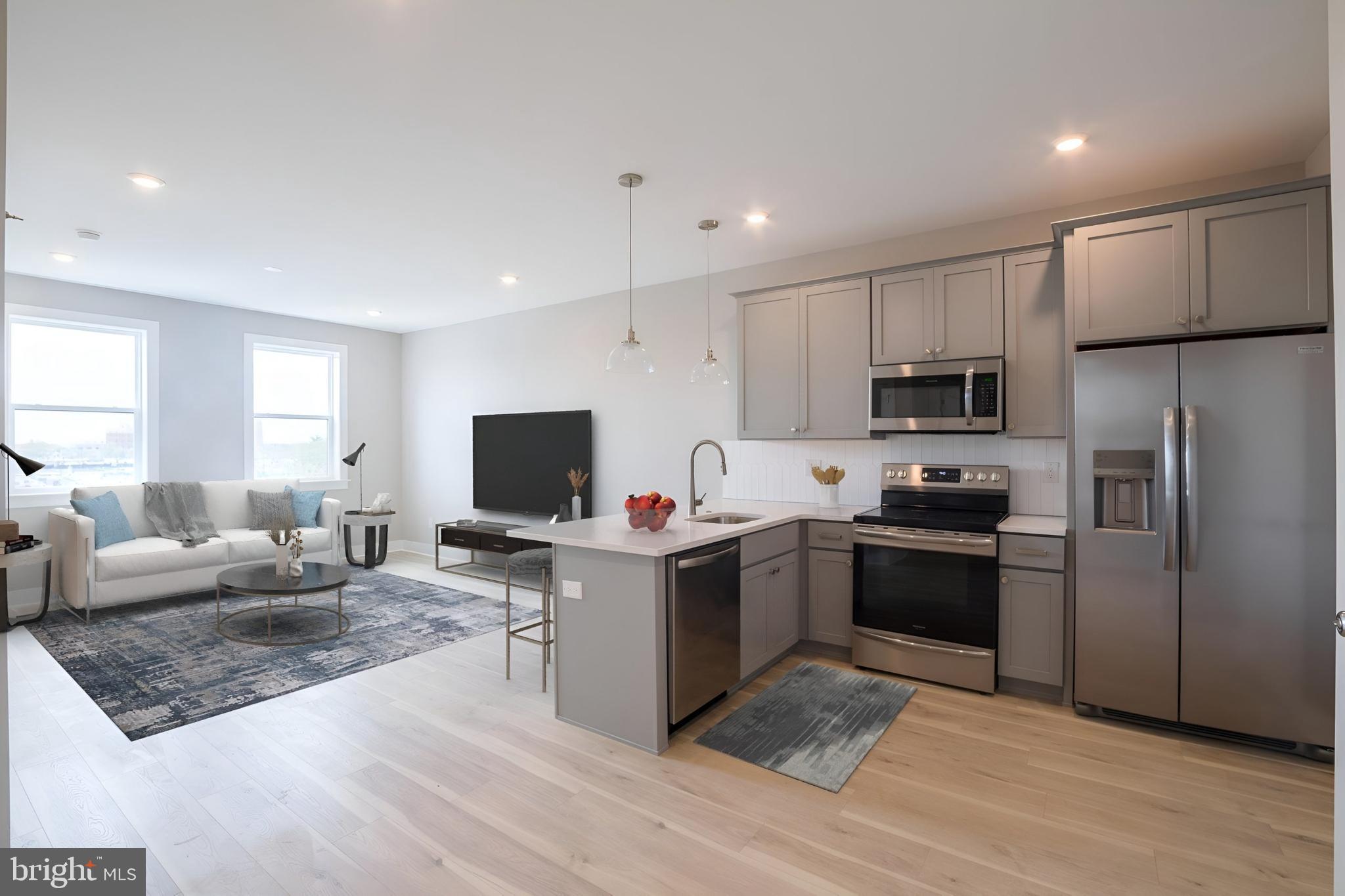 a view of kitchen with microwave stove top oven and cabinets