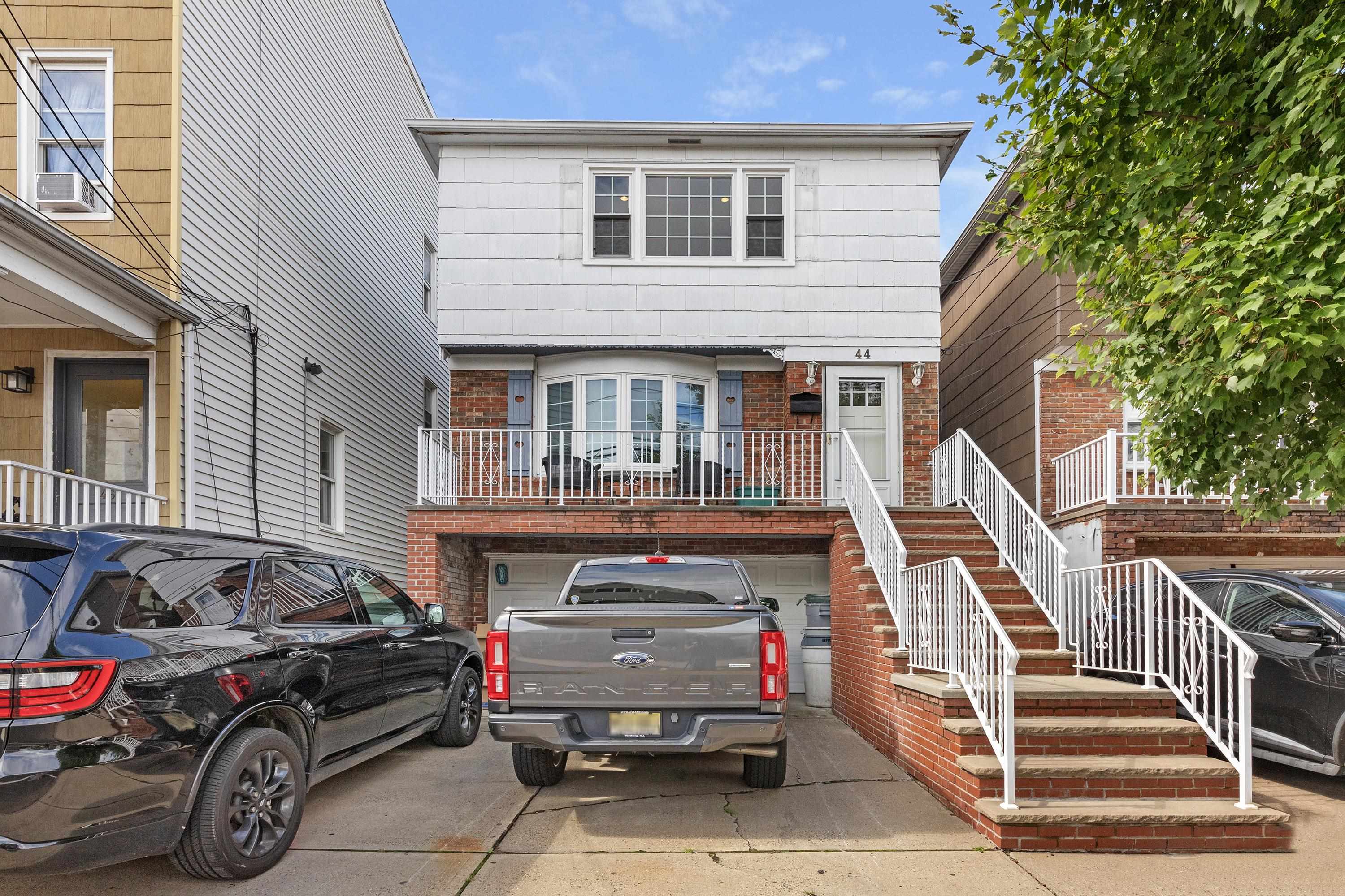 a front view of a house with parking