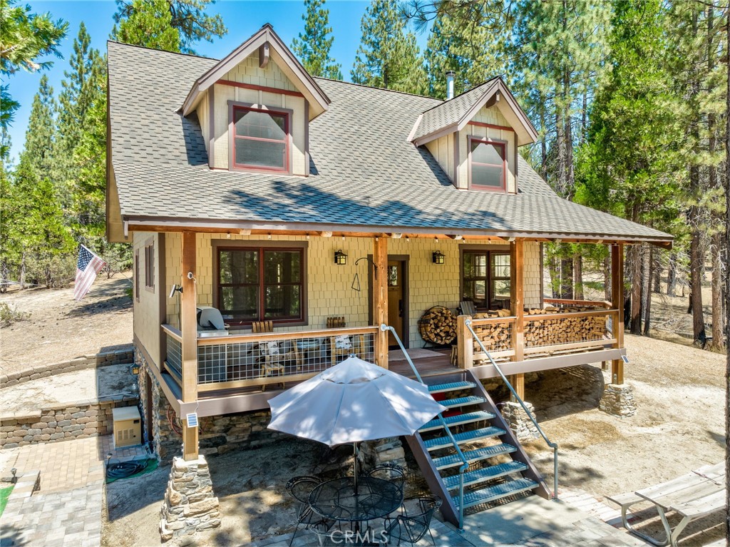 a view of a house with a patio and a yard