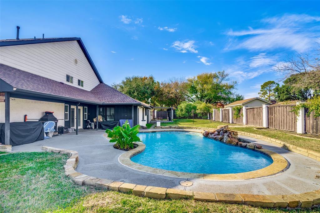 View of swimming pool with a patio area and a yard