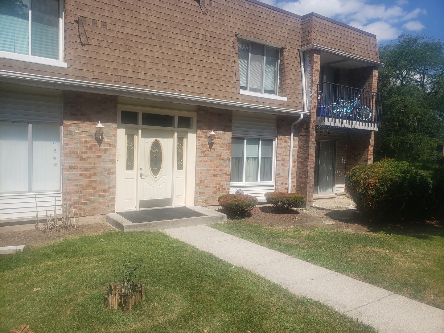 a front view of a house with garden