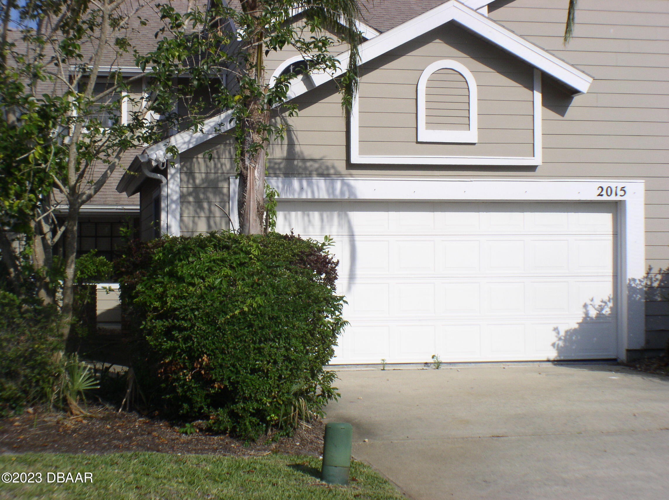 a view of a house with a yard and garage