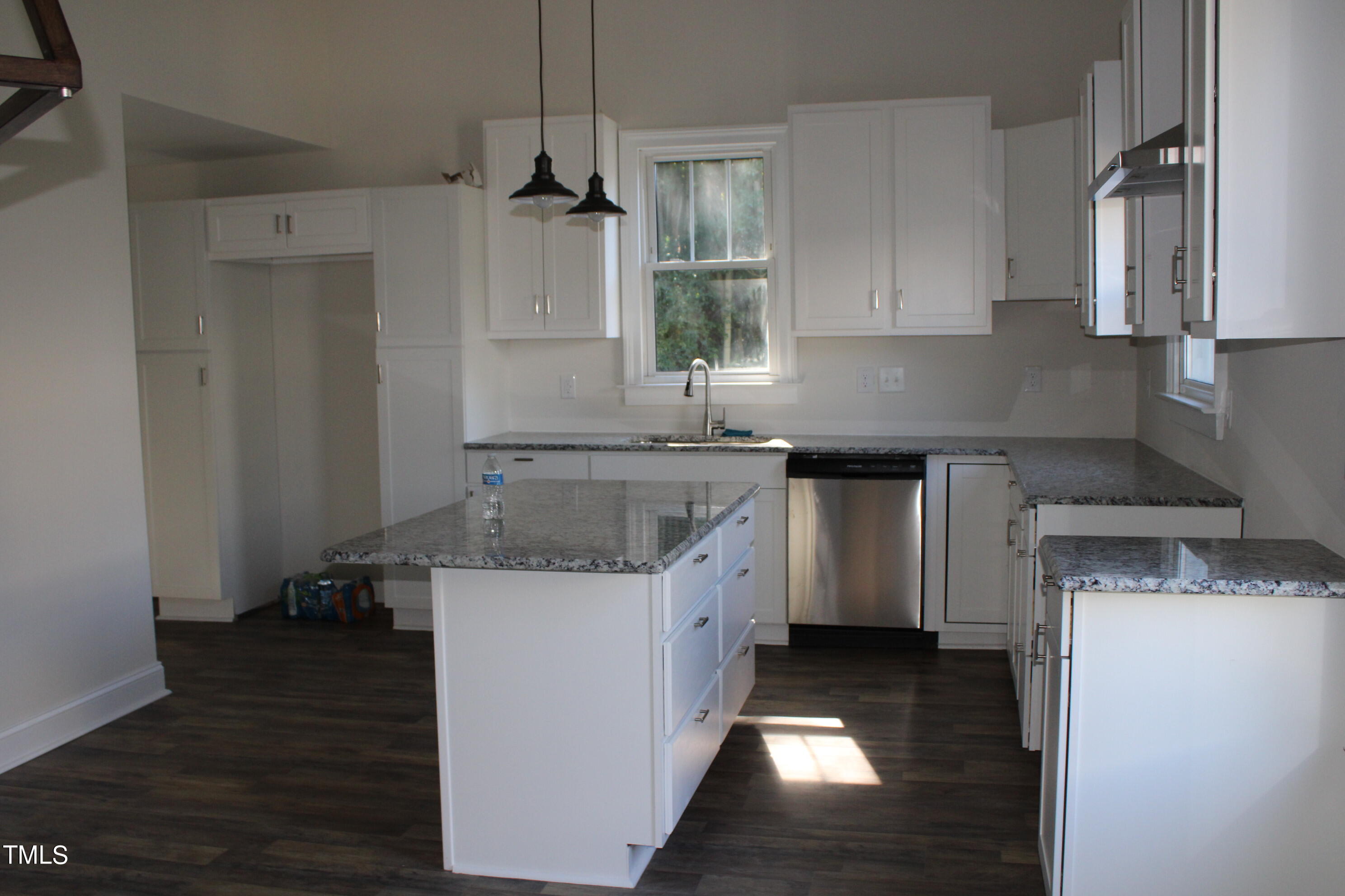 a kitchen with a sink a stove and cabinets