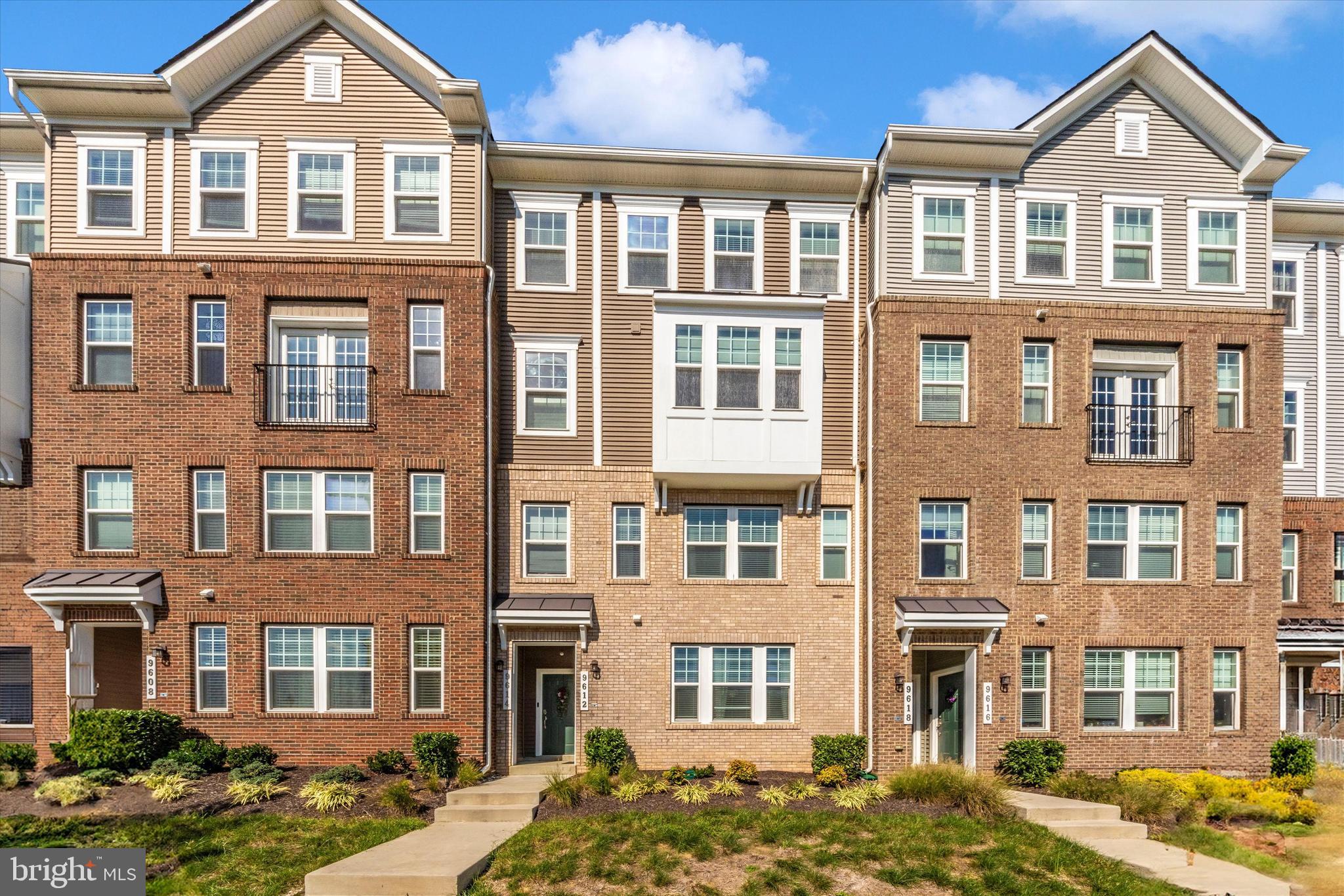 a front view of a residential apartment building with a yard