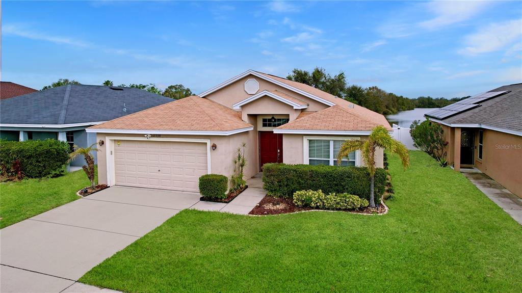 a front view of a house with a yard and garage