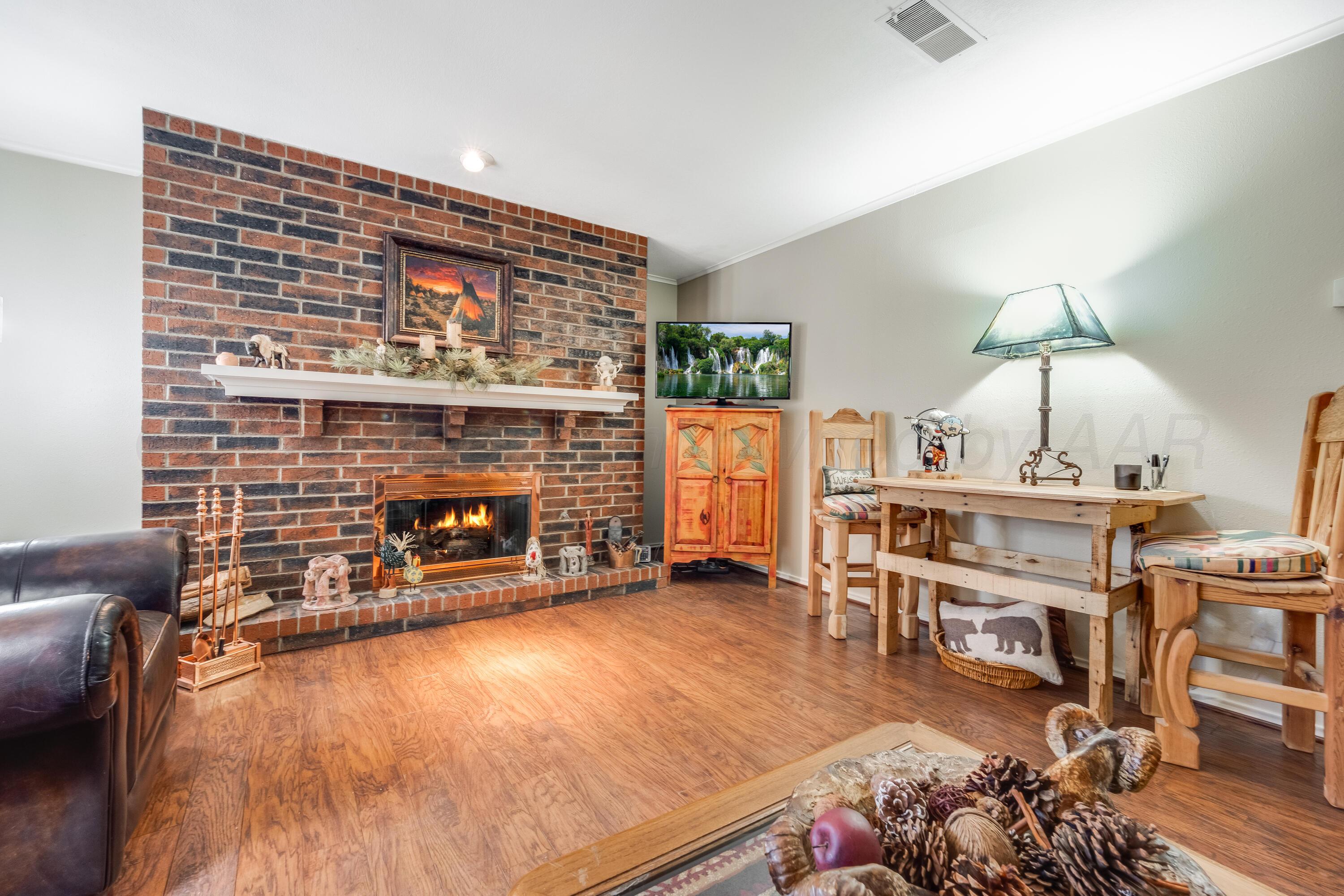 a living room with furniture a fireplace and a table