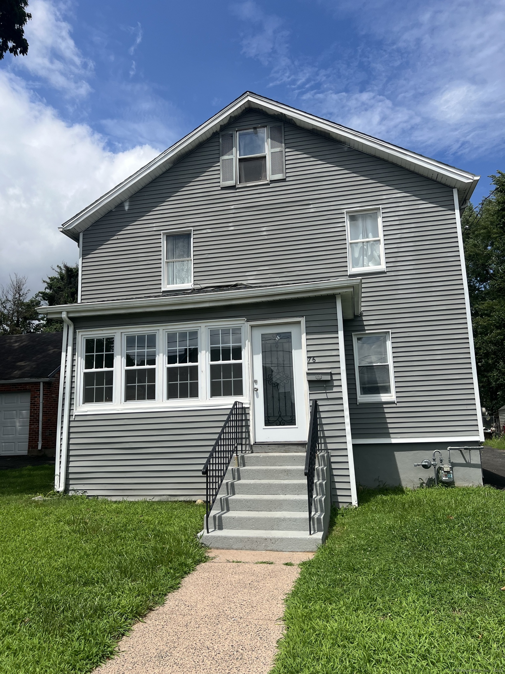 a front view of a house with a yard