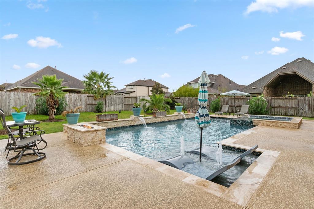 This stunning home has an entertainer's paradise in the backyard! The pool’s graceful waterfalls create a soothing ambiance, while the spa provides an inviting escape for unwinding after a long day.