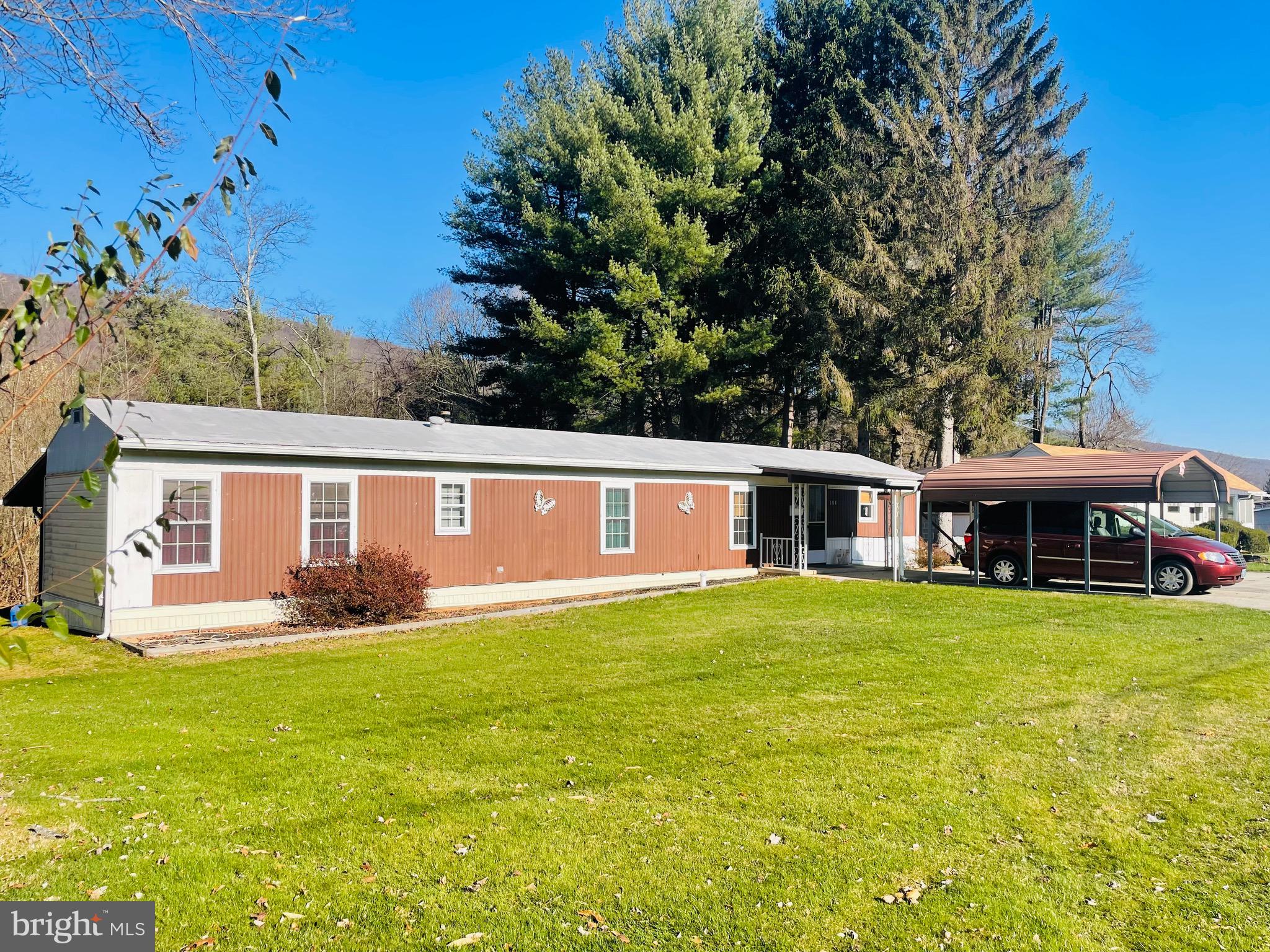 a front view of house with yard and green space