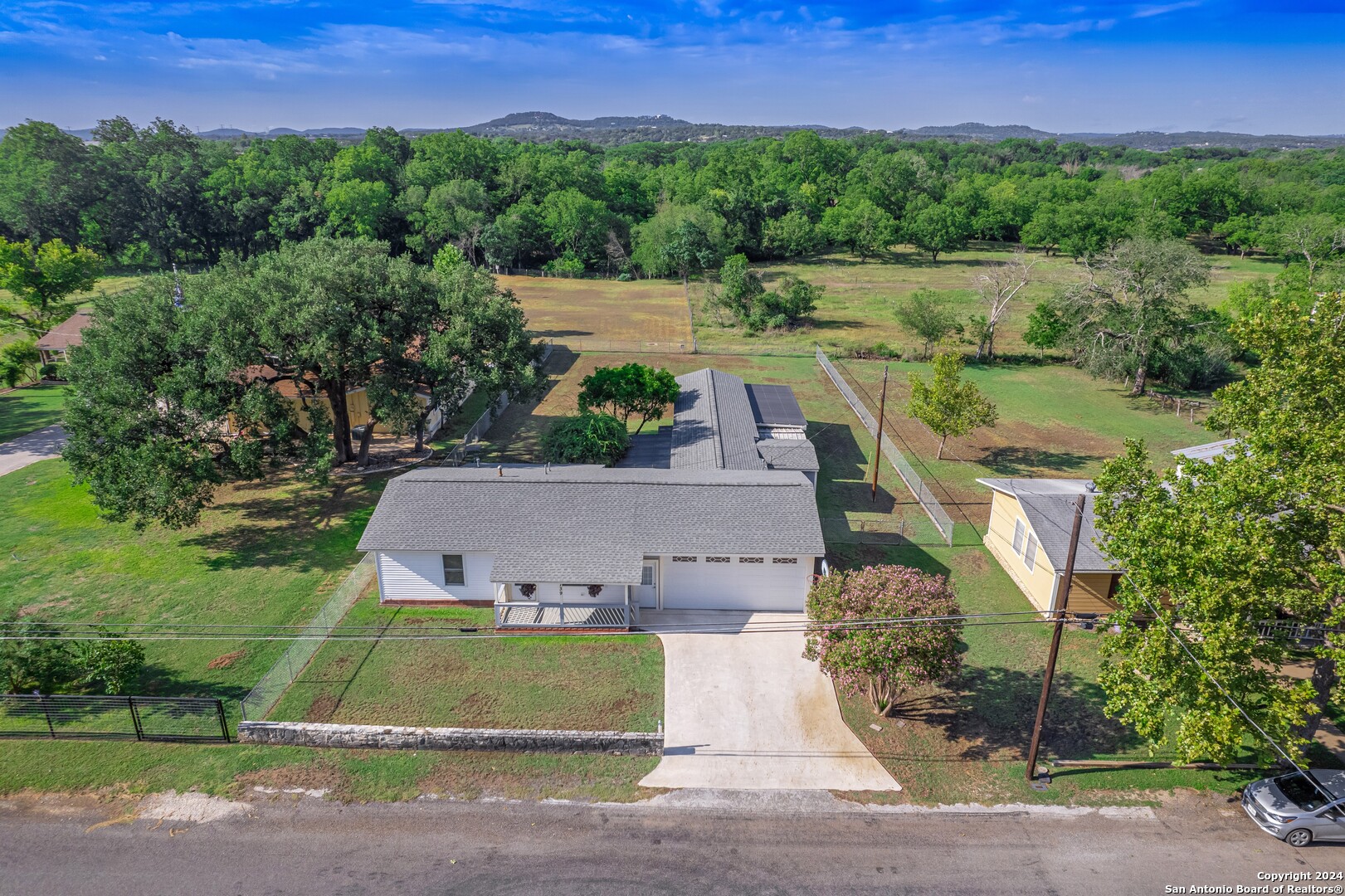 an aerial view of a house with a garden and a yard