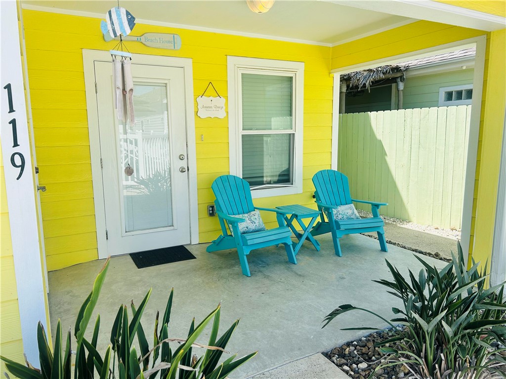 a view of a porch with chairs and table