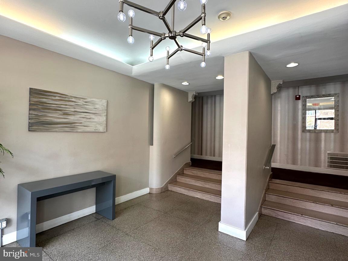 a view of a hallway with stairs and a furniture