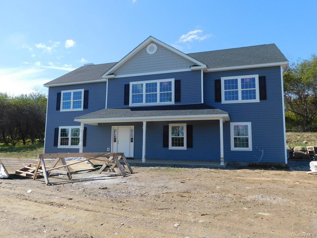 a front view of a house with yard and parking space