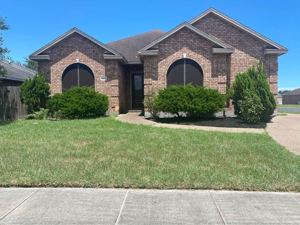 a front view of a house with a yard