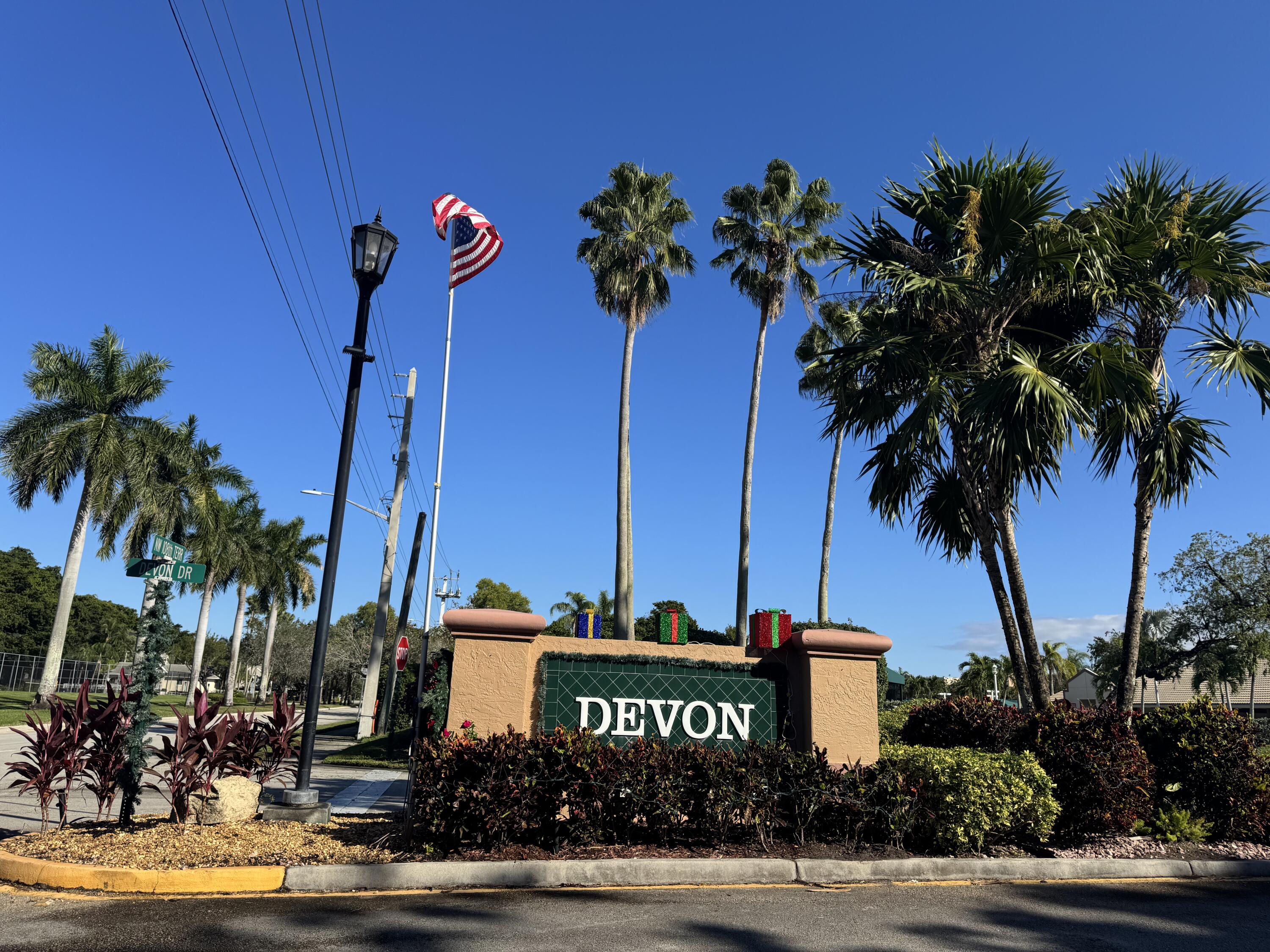 a front view of a building with palm trees