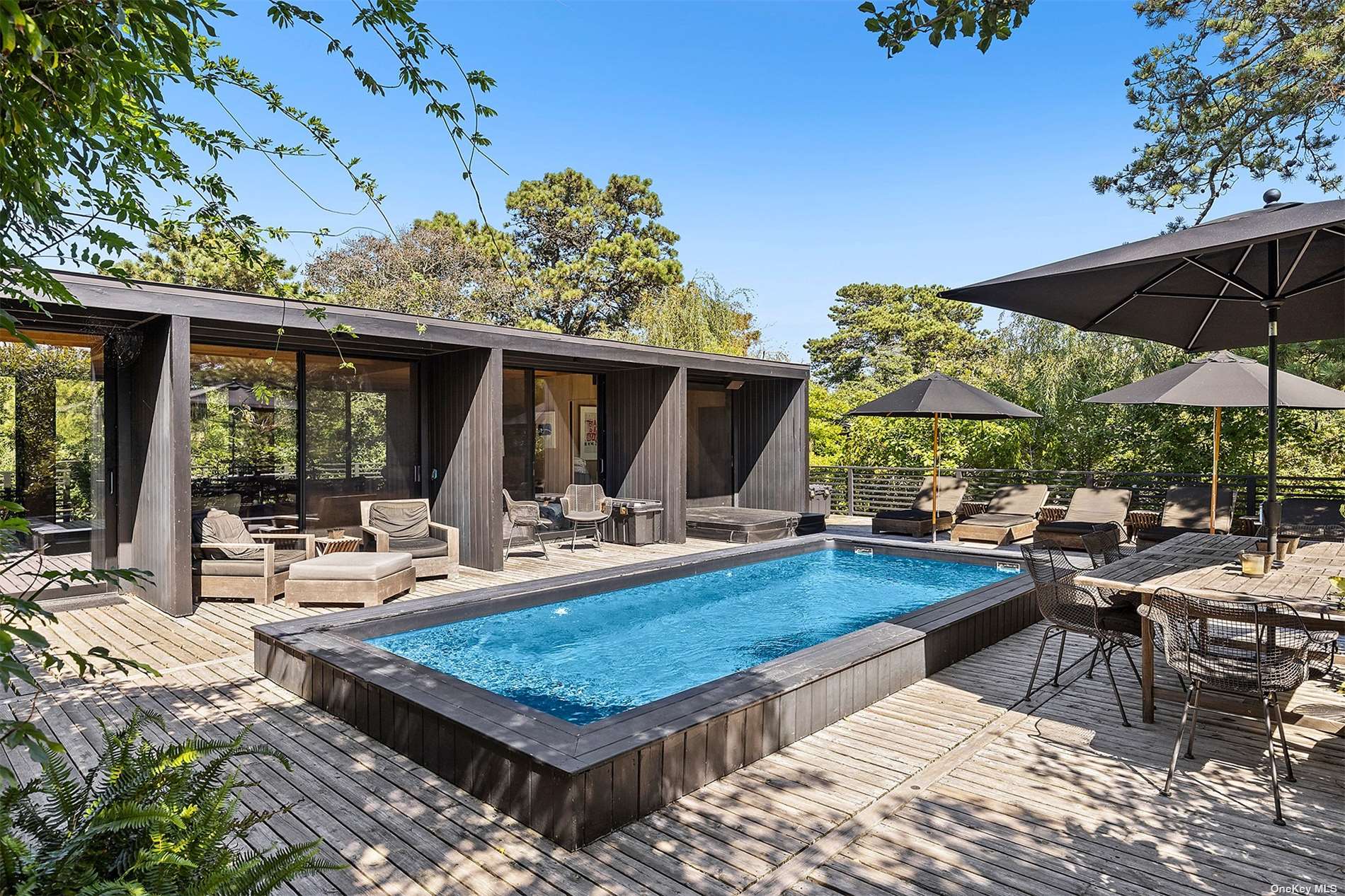 a view of swimming pool with outdoor seating and plants