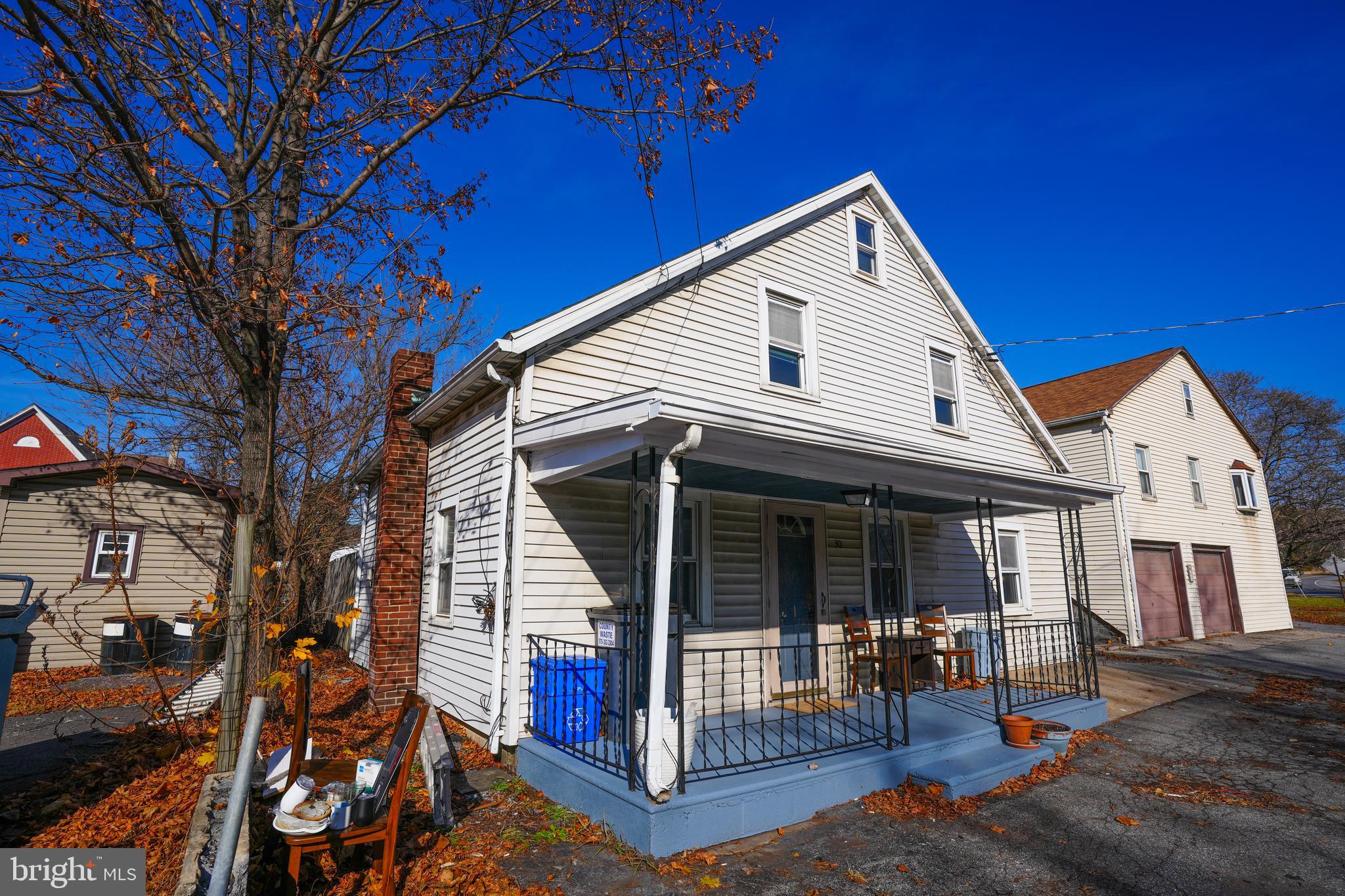 a view of a house with a yard and porch