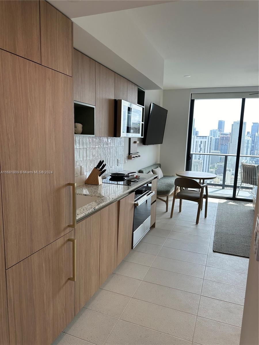 a kitchen with a sink appliances and cabinets