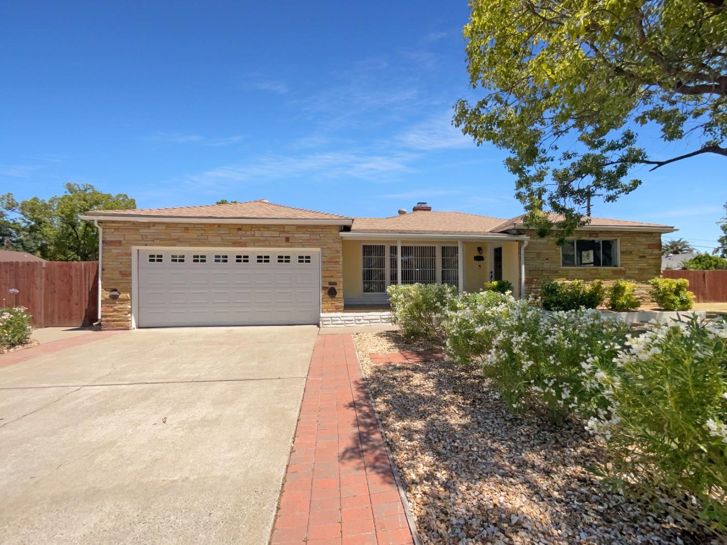 a view of a house with a tree in the background