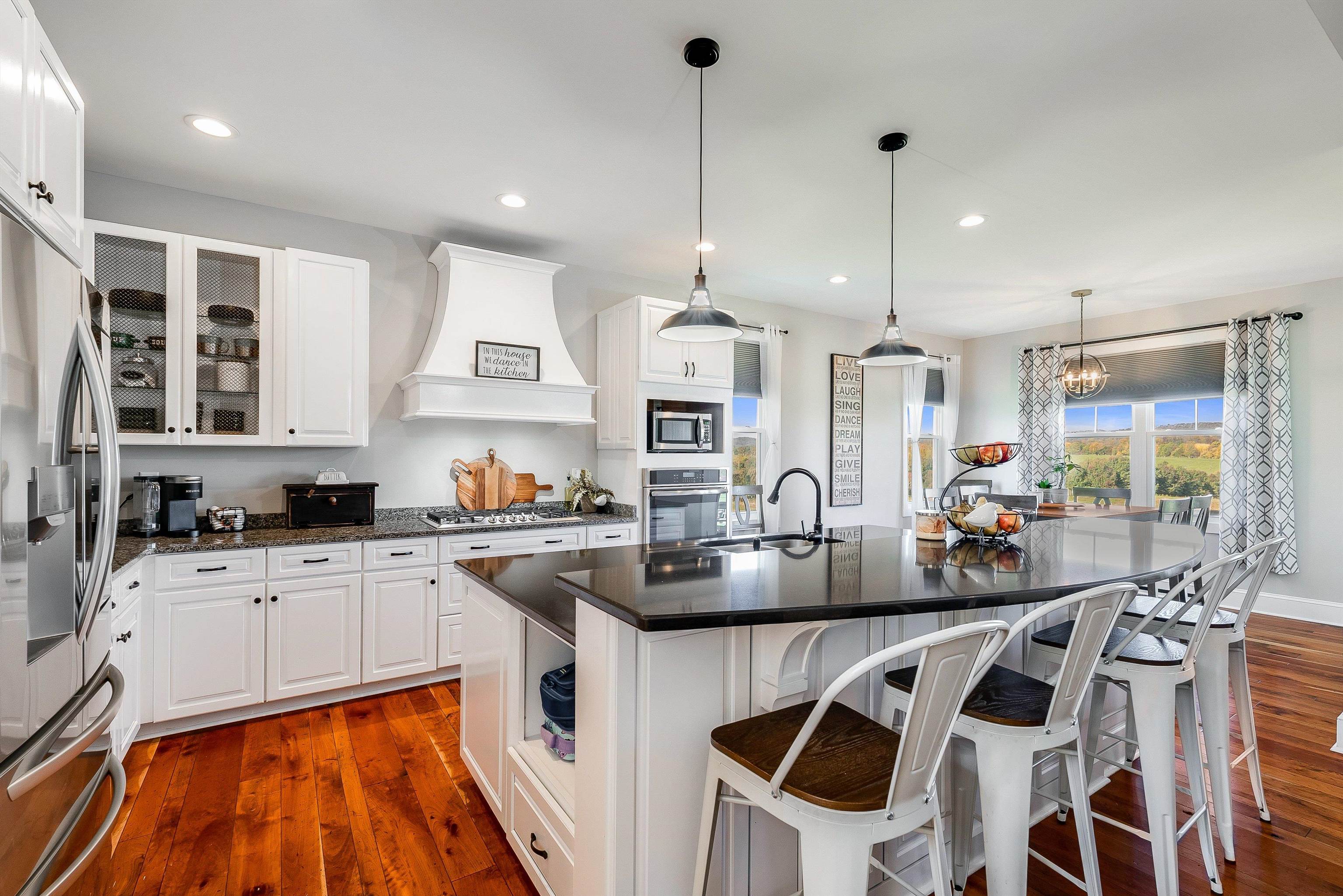 a kitchen with stainless steel appliances kitchen island granite countertop a sink and cabinets