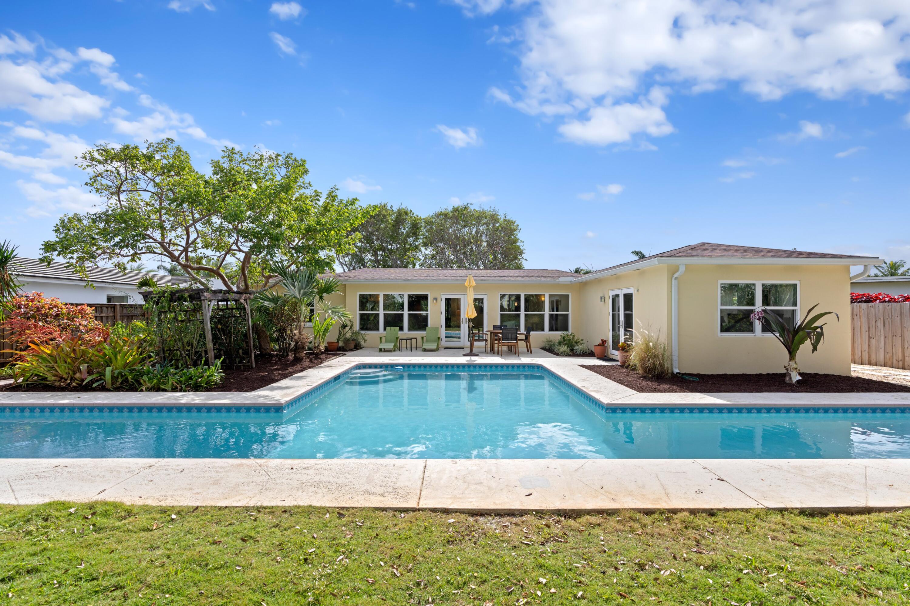 a view of a house with swimming pool and yard