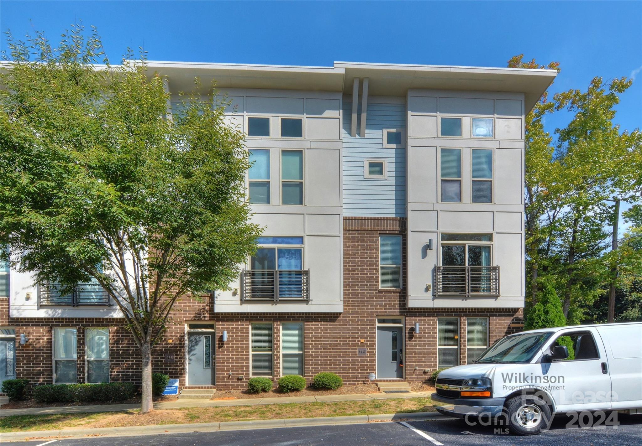 a front view of a residential apartment building with a yard