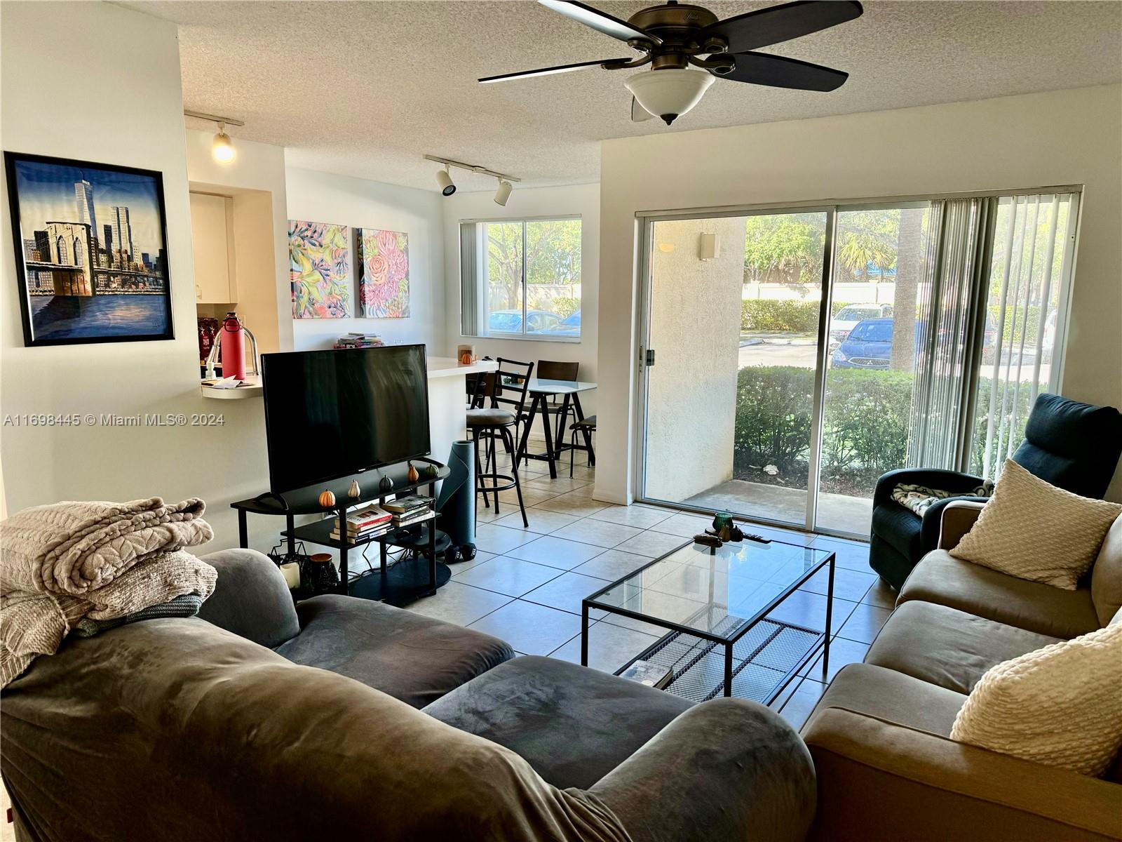 a living room with furniture and a flat screen tv with wooden floor