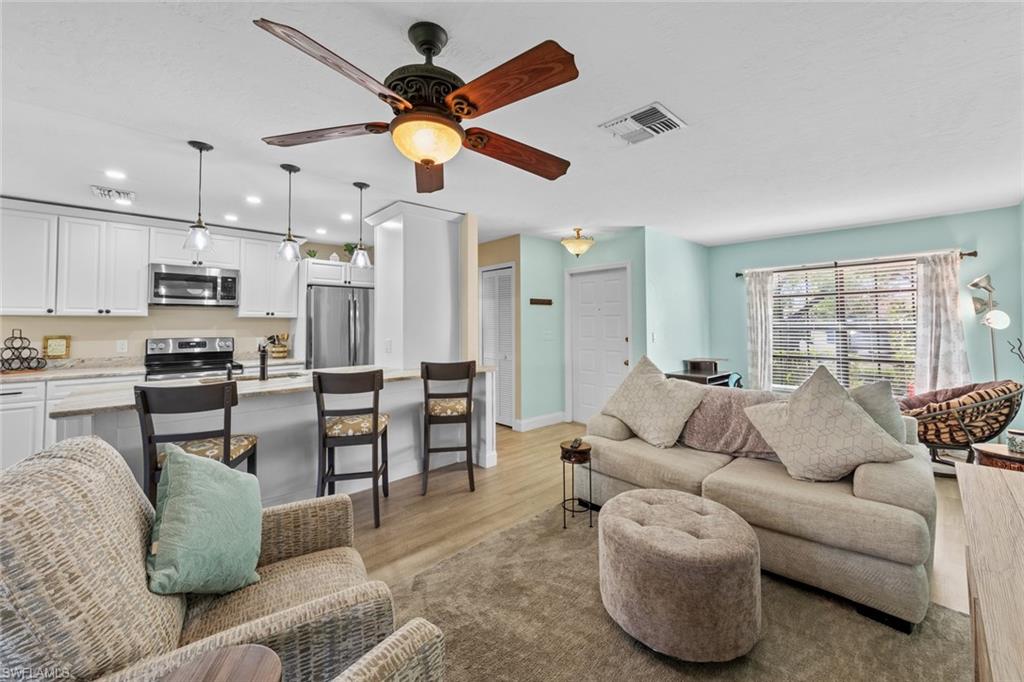 Living room featuring light hardwood / wood-style floors and ceiling fan