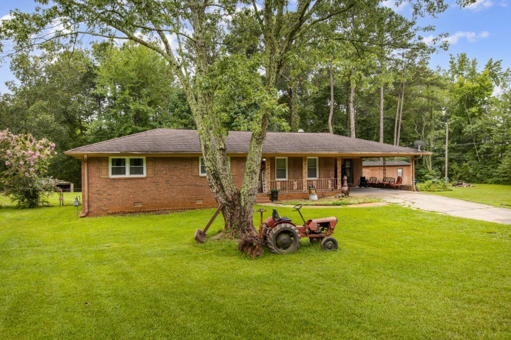 a view of a house with a yard porch and sitting area