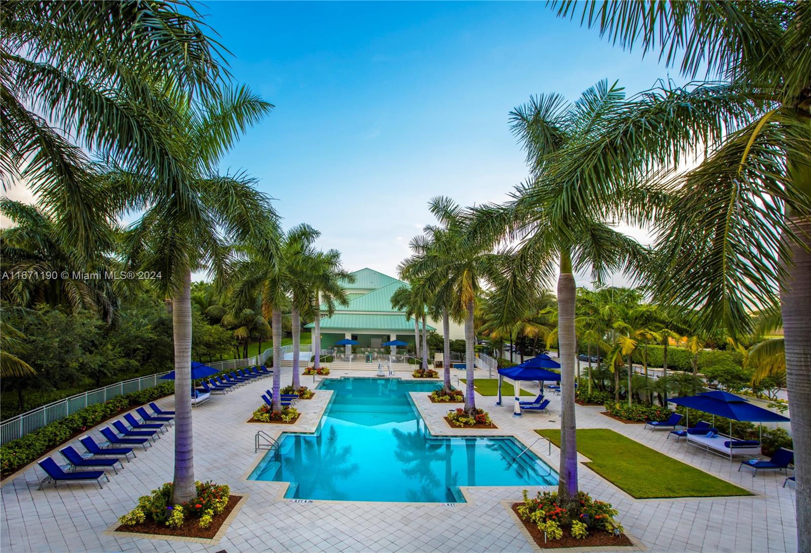 a view of a swimming pool with lounge chairs in a patio