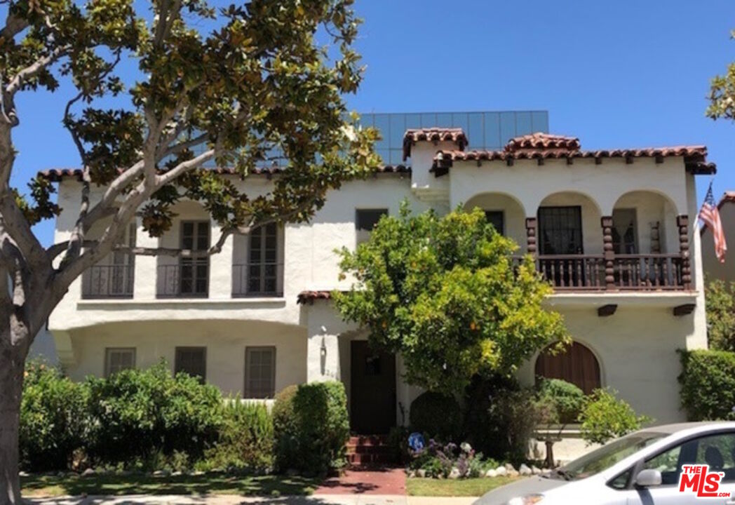 a front view of a house with trees