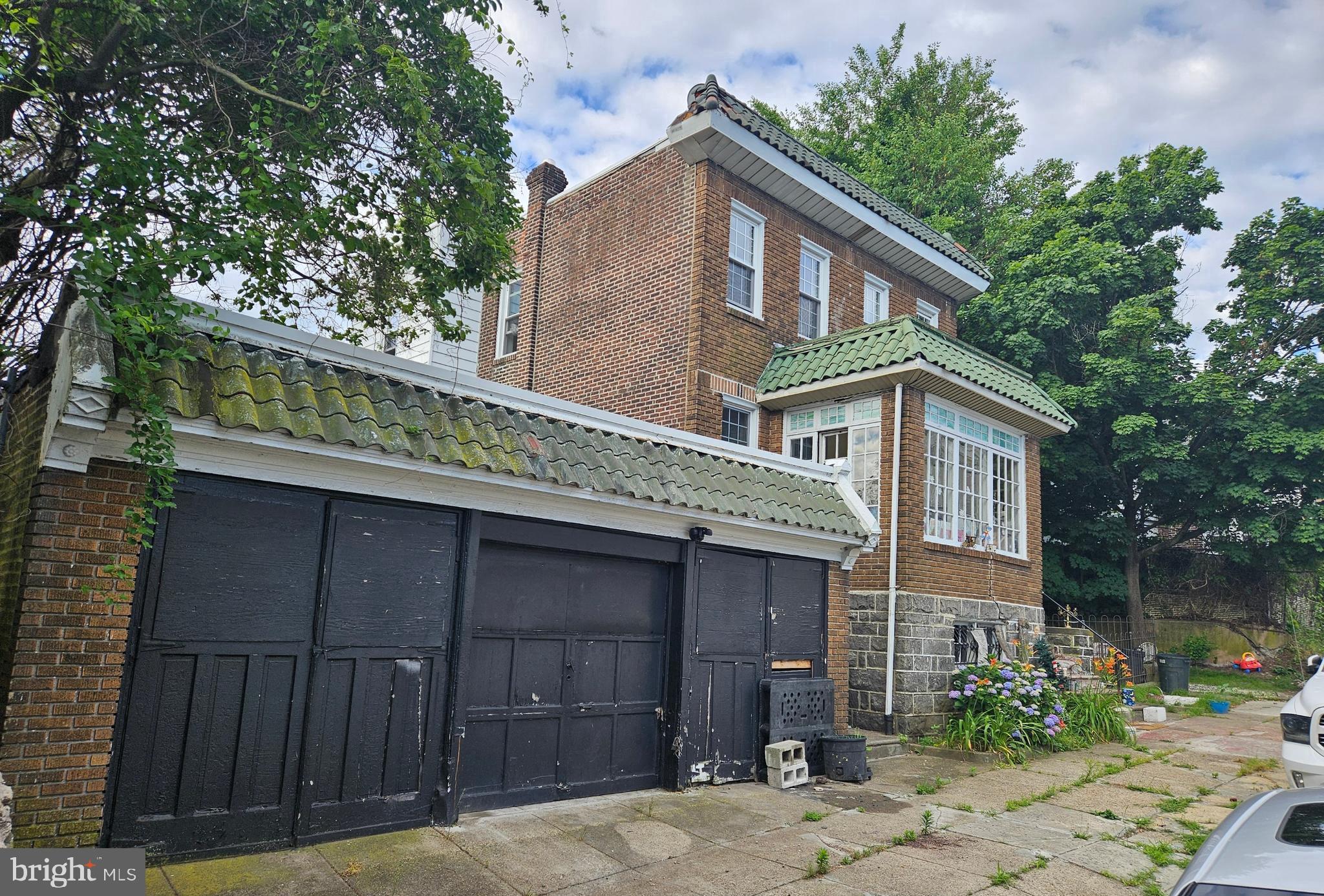 a front view of a house with a garden