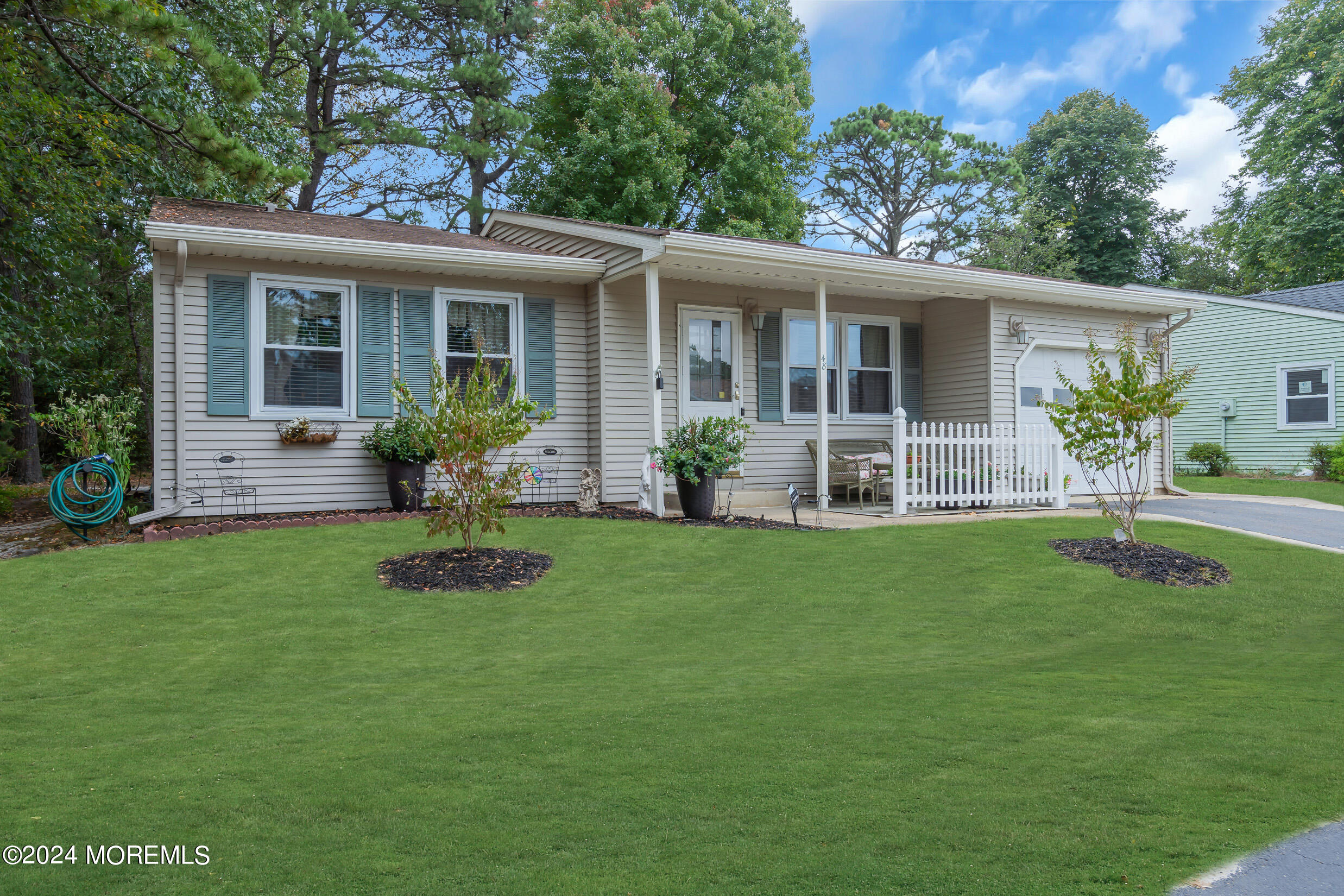 a front view of house with yard and outdoor seating