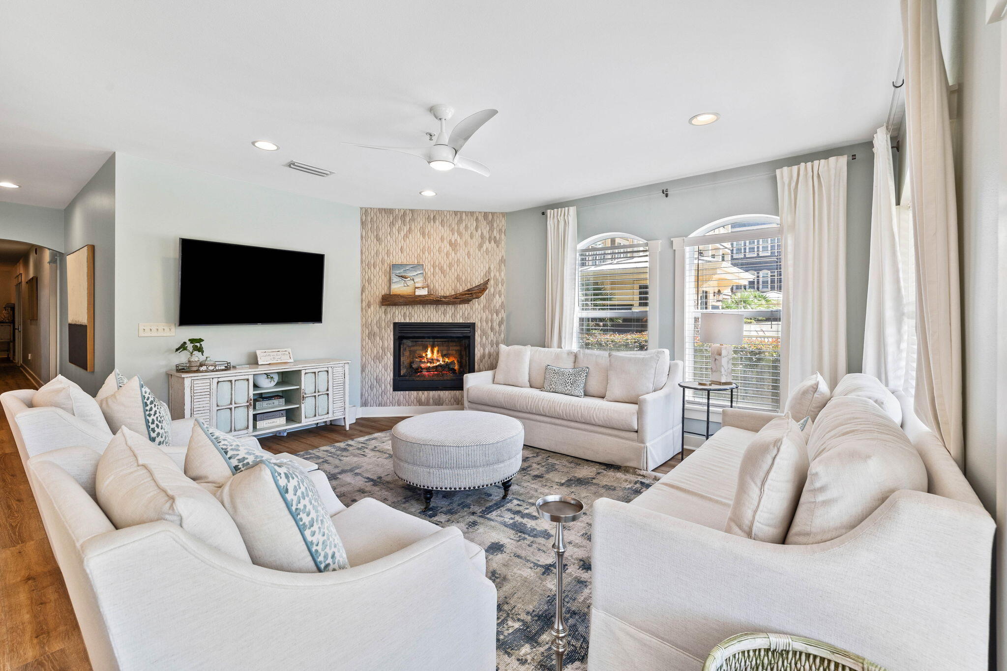 a living room with furniture a flat screen tv and a fireplace