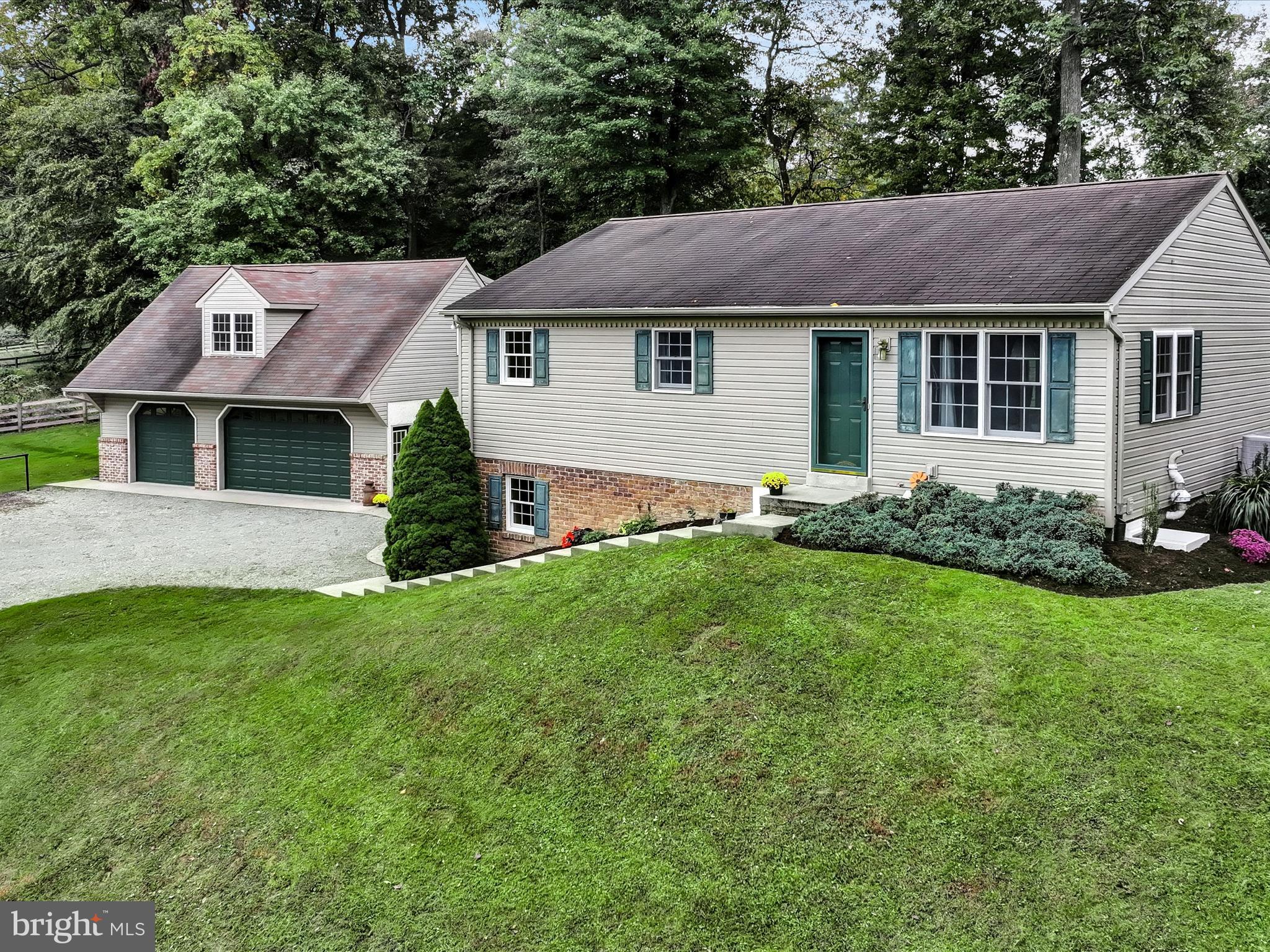 a aerial view of a house with a yard and potted plants