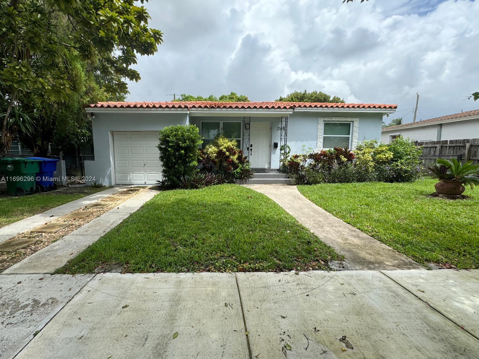 a view of a house with a garden and plants