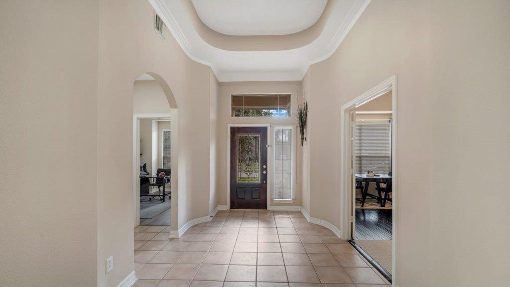 an entryway with a white walls and stairs