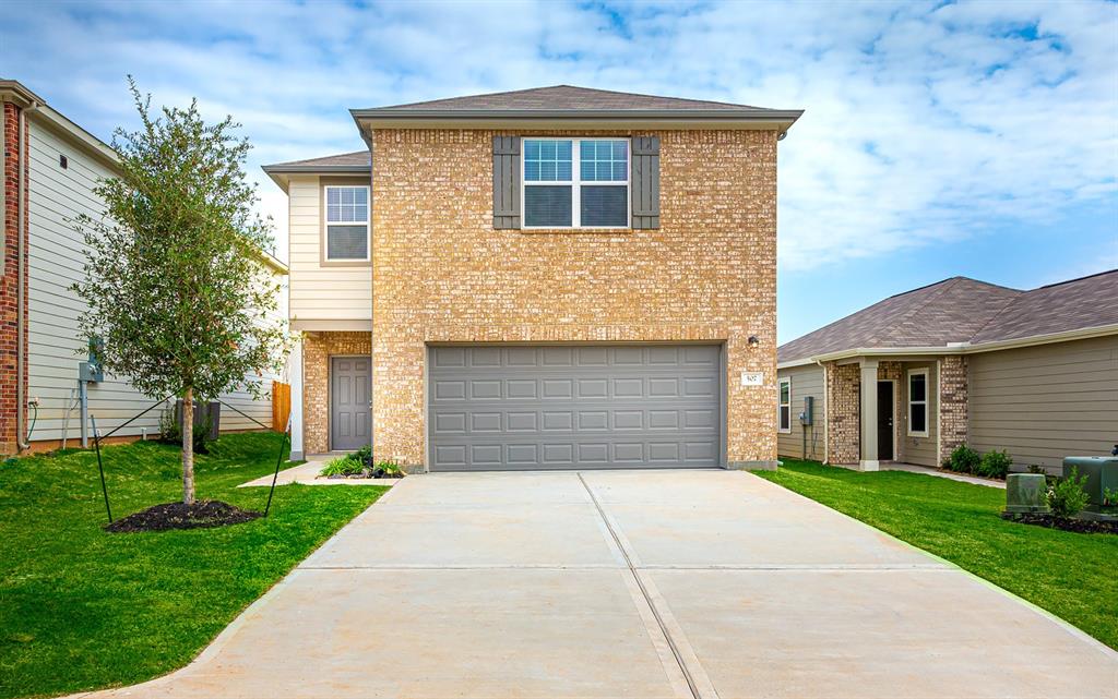 a front view of house with yard and green space