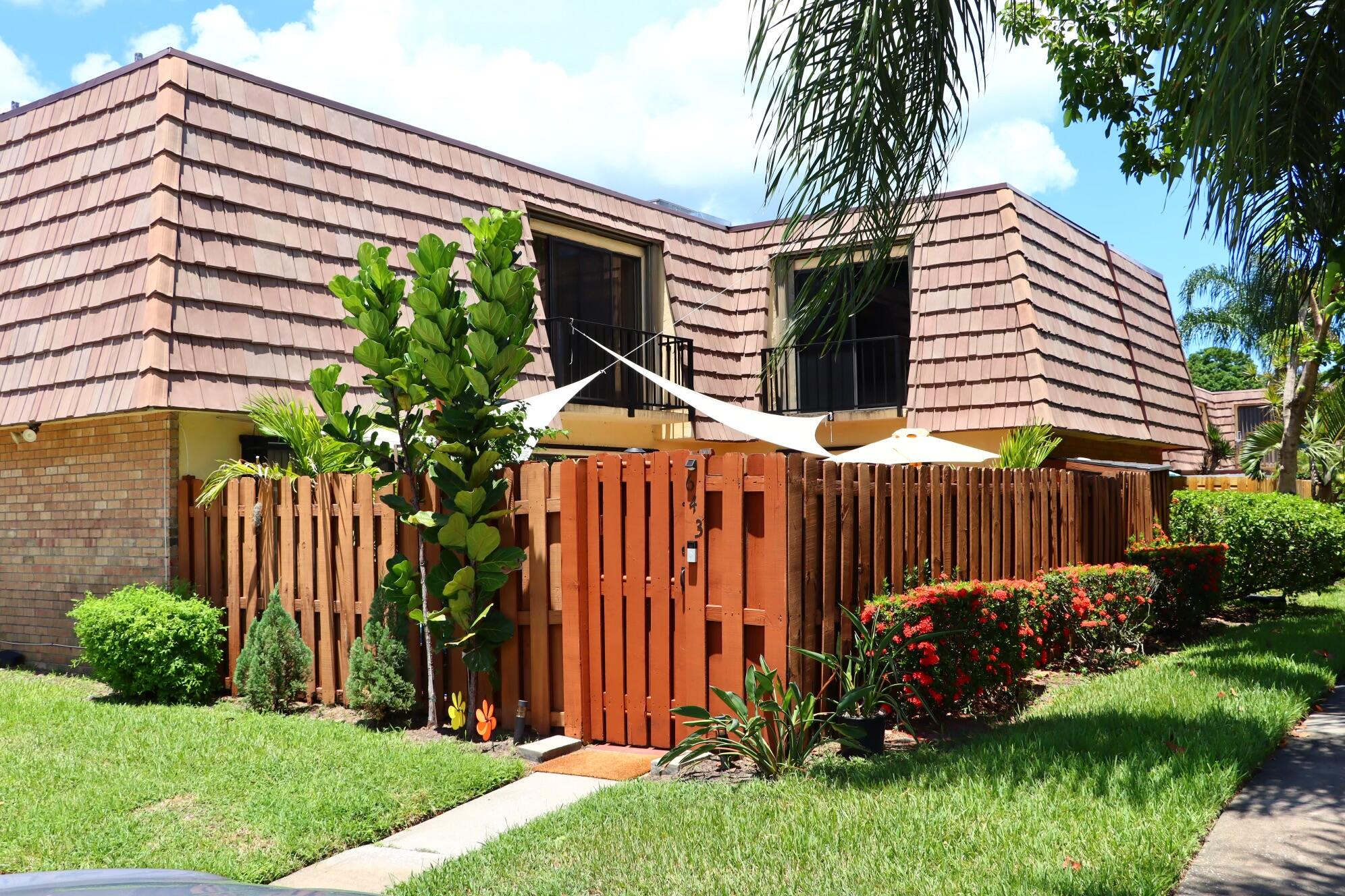 a view of a house with a yard and plants