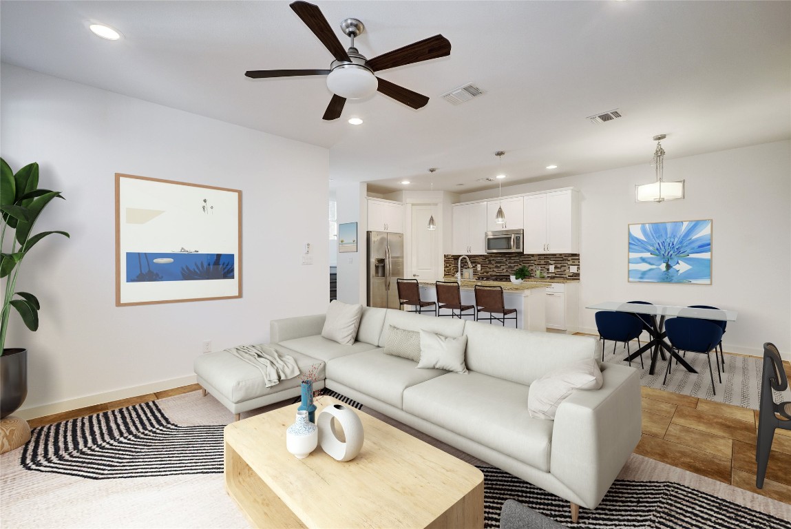 a living room with furniture and a view of kitchen