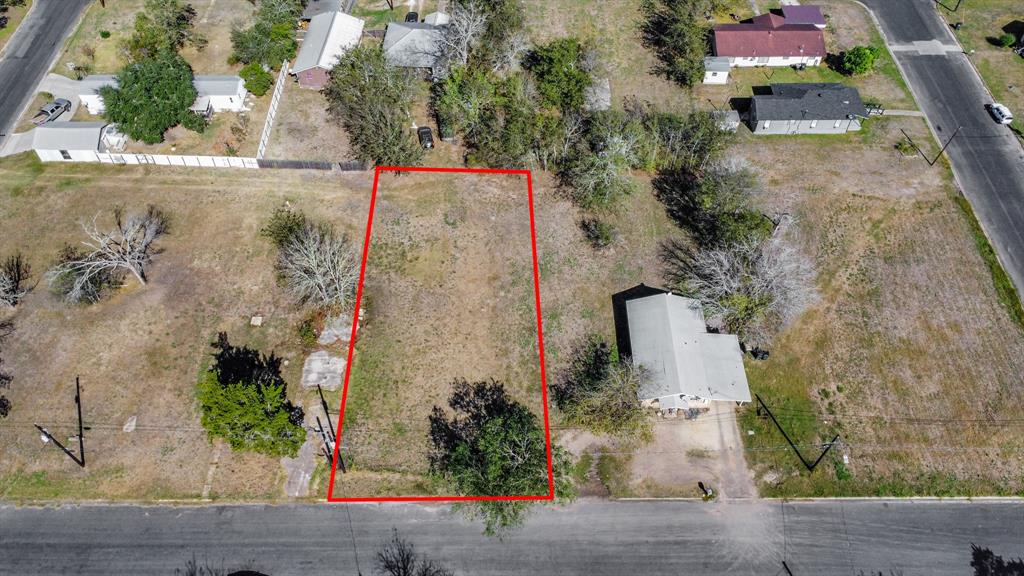 an aerial view of a house with a yard