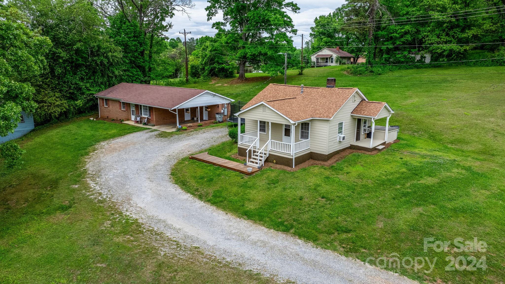 a aerial view of a house with a yard table and chairs