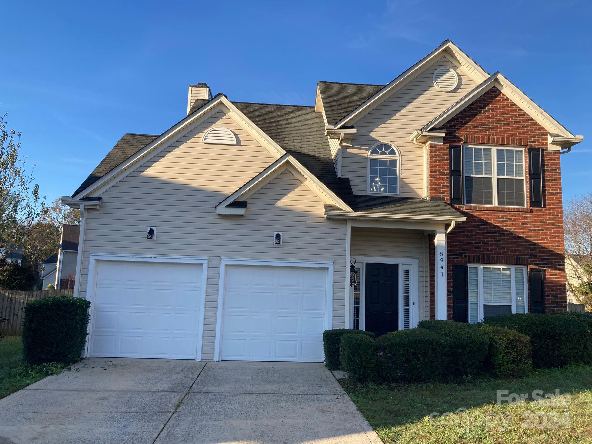 a front view of a house with garage