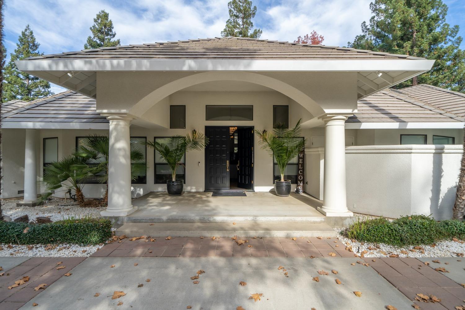 a front view of a house with garden