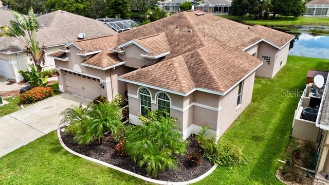 an aerial view of a house with a yard and potted plants