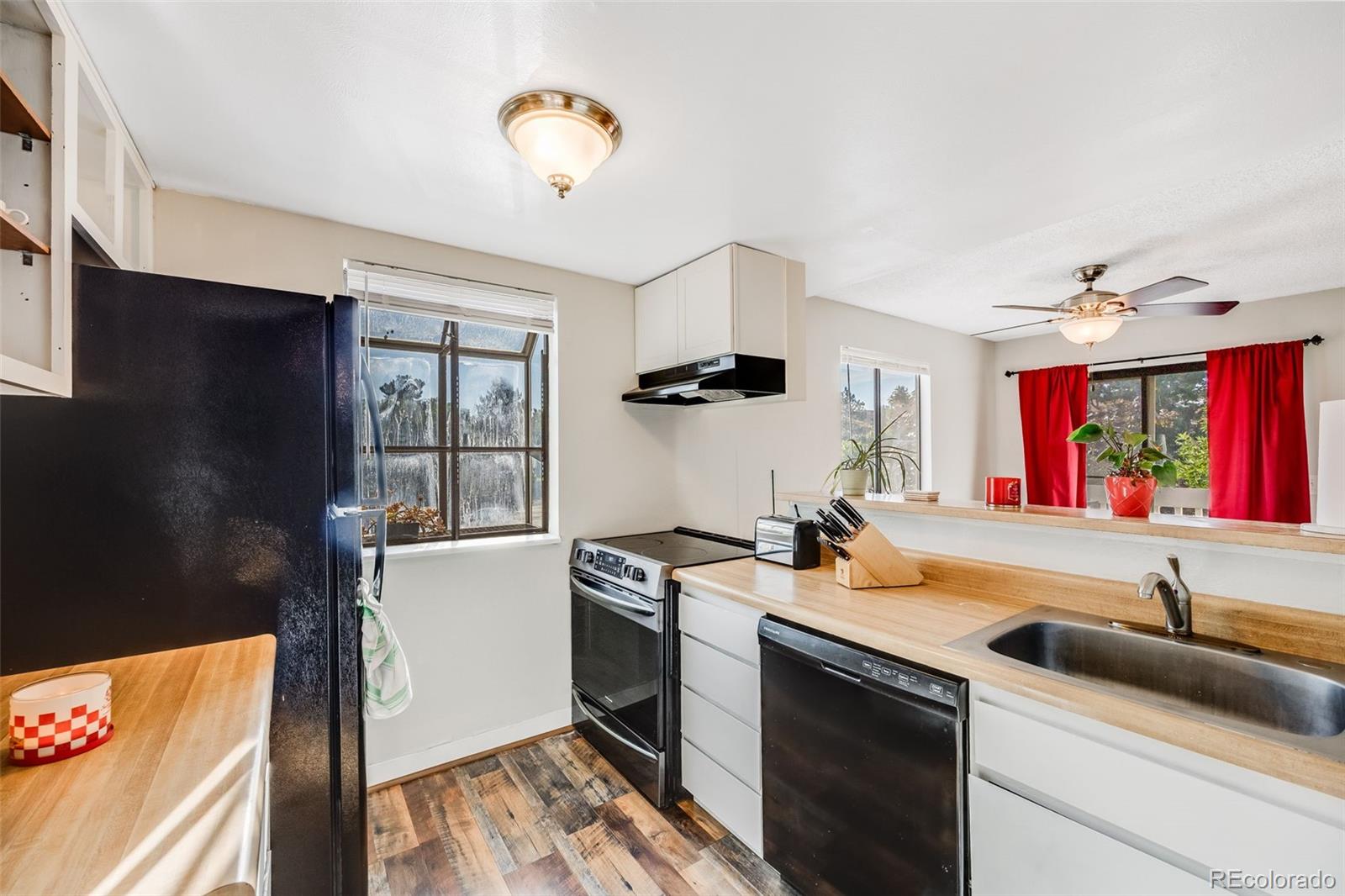 a kitchen that has a sink and a stove